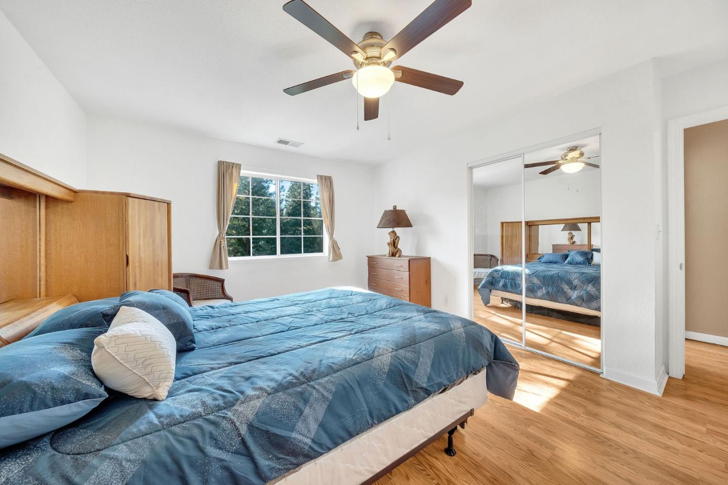 26161 Sugar Pine Drive Pioneer, CA 95666 - Photo 37 of 57 a bedroom with a large bed and a chandelier fan