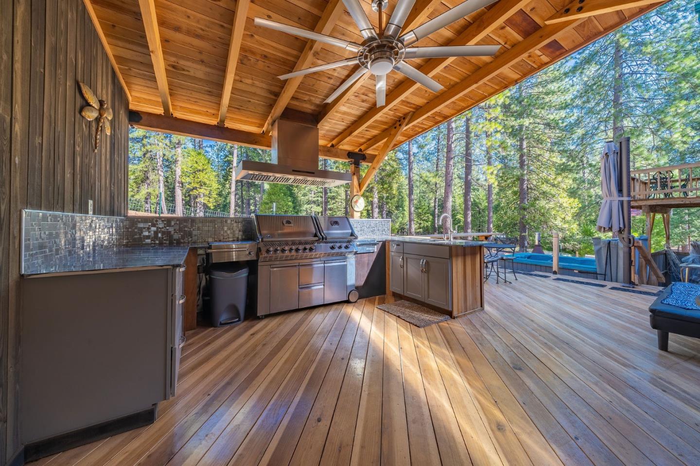 26161 Sugar Pine Drive Pioneer, CA 95666 - Photo 53 of 57 a kitchen with stainless steel appliances wooden floors and wooden cabinets