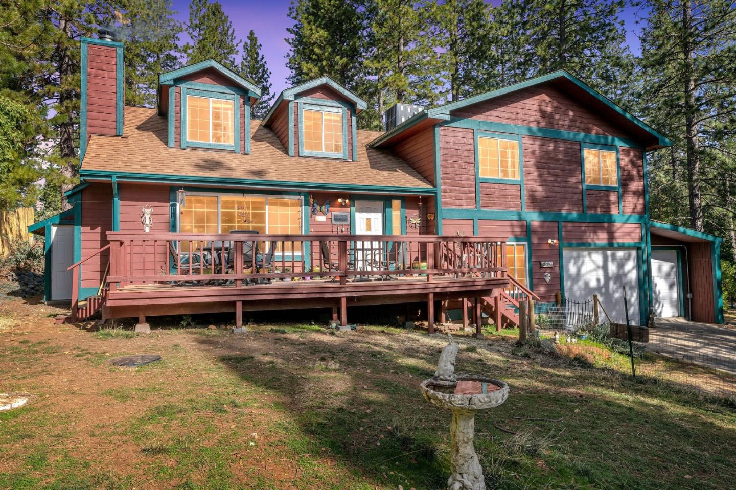 26161 Sugar Pine Drive Pioneer, CA 95666 - Photo 56 of 57 a front view of a house with a yard glass top table and chairs