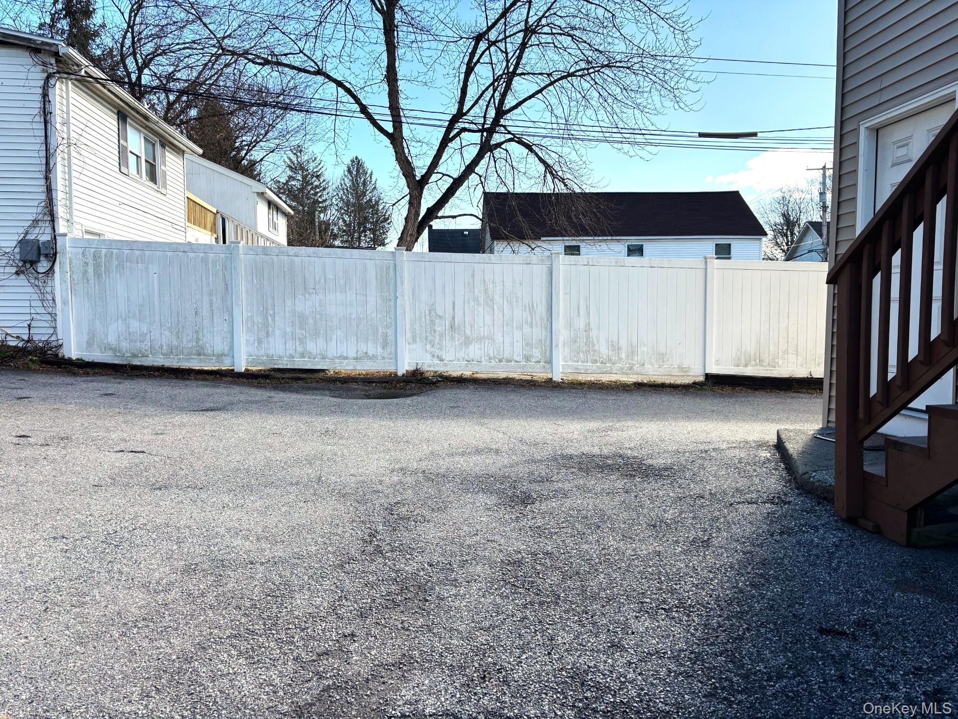 454 Highway 376, Unit 1A Hopewell Junction, NY 12533 - Photo 11 of 11 a view of a backyard with a large tree and wooden fence