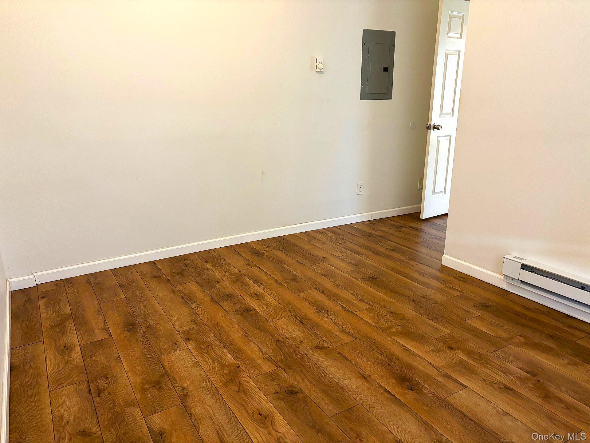 454 Highway 376, Unit 1A Hopewell Junction, NY 12533 - Photo 10 of 11 an empty room with wooden floor
