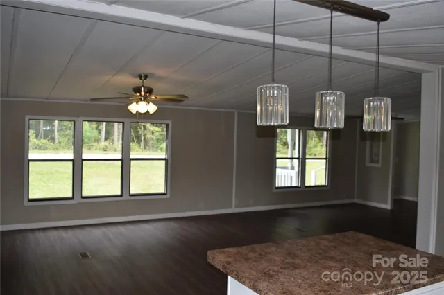 a kitchen with a window and wooden floor