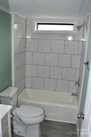 a bathroom with a toilet and a bathtub
