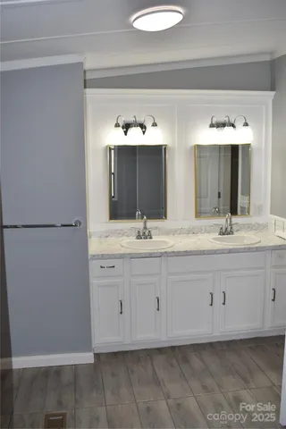 a bathroom with a double vanity sink and a mirror