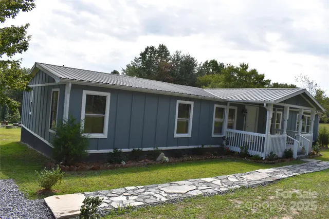 a view of house with backyard space and garden