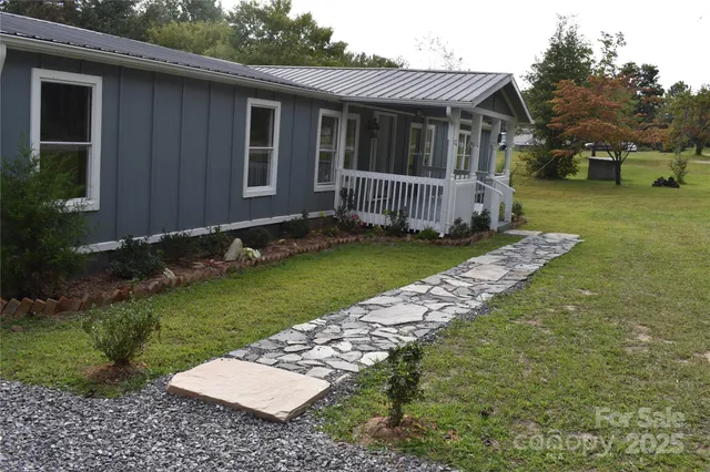 a view of a house with a backyard