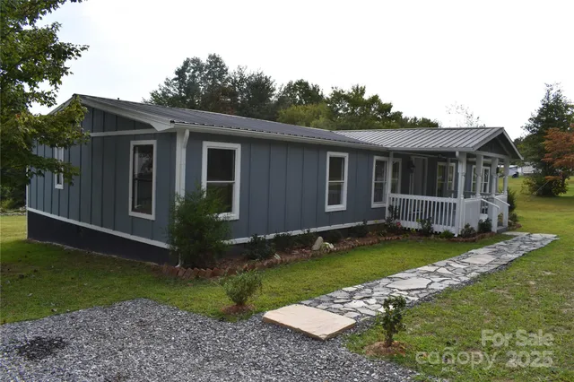 a view of house with backyard and garden