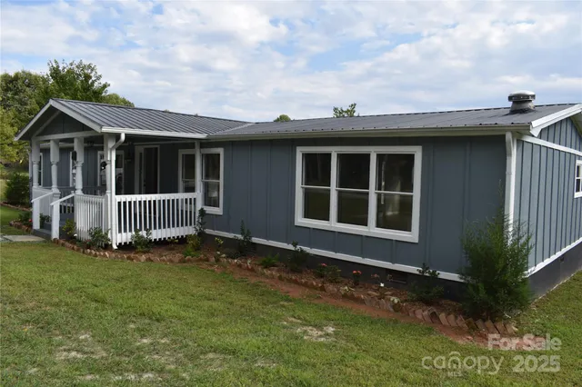 a view of house with backyard and garden