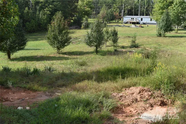 a backyard of a house with a yard and lake view