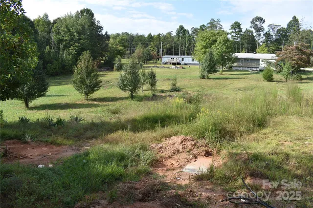 a backyard of a house with a yard and outdoor seating