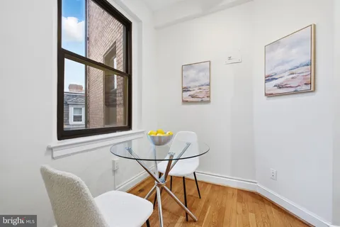 a view of a workspace with furniture and a window