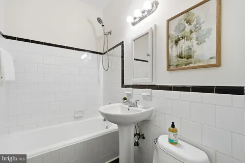 a bathroom with a sink mirror and a bathtub