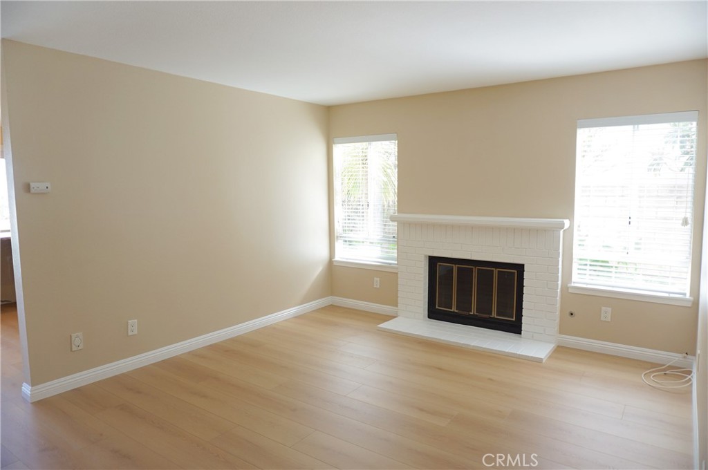 19584 Shadow Glen Circle Porter Ranch, CA 91326 - Photo 8 of 72 an empty room with a fireplace and window