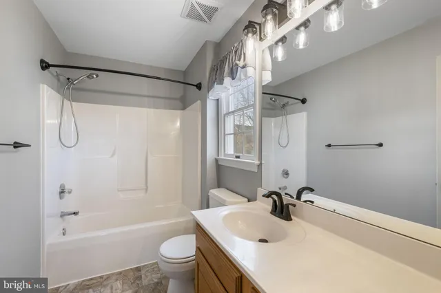 a bathroom with a sink a toilet and a bathtub