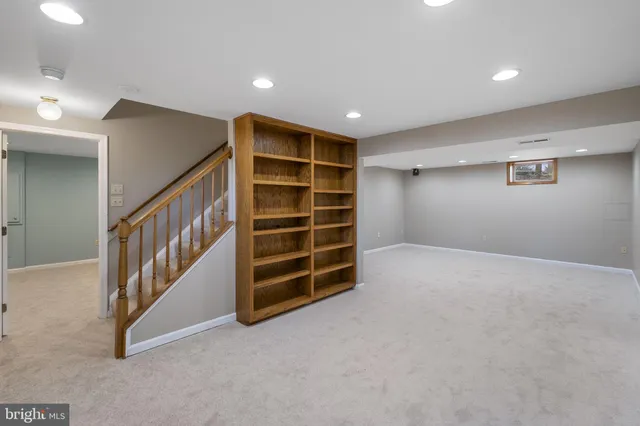 a view of an empty room with a staircase