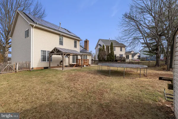 a view of backyard with roof deck