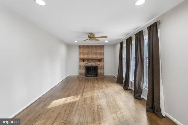 wooden floor in an empty room with a fireplace