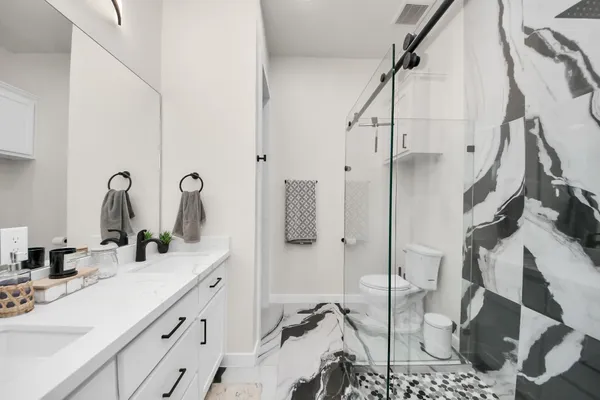 a bedroom with a large bed and a ceiling fan