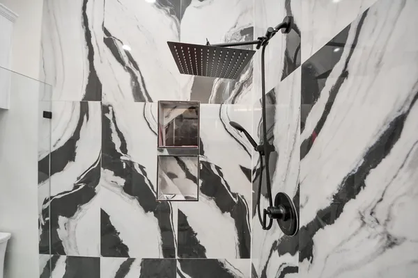 a view of a yard with a large tree and wooden fence