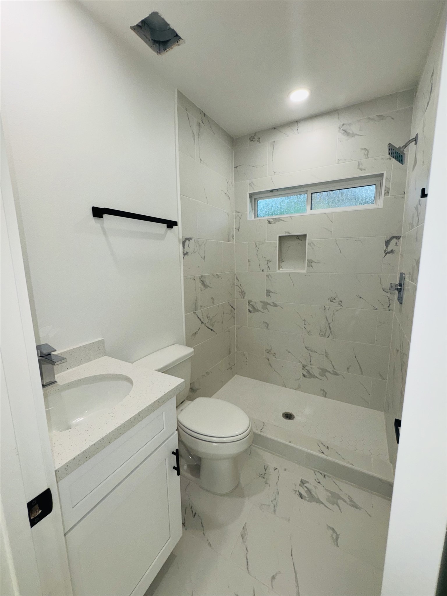 1235 West Gray Street, Unit 1 Houston, TX 77019 - Photo 3 of 10 a bathroom with a sink a toilet and shower