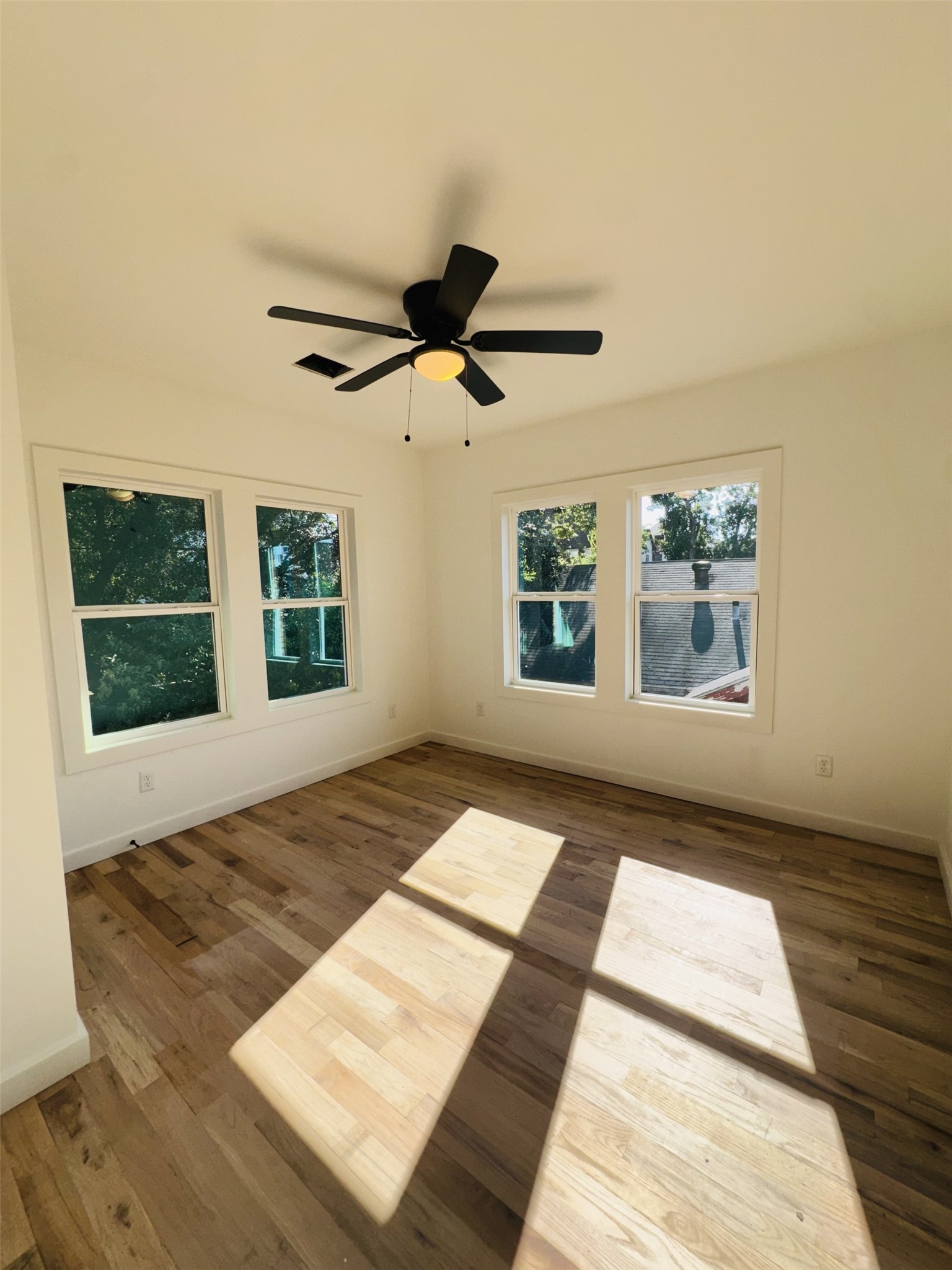 1235 West Gray Street, Unit 1 Houston, TX 77019 - Photo 4 of 10 a view of a bedroom with wooden floor and windows