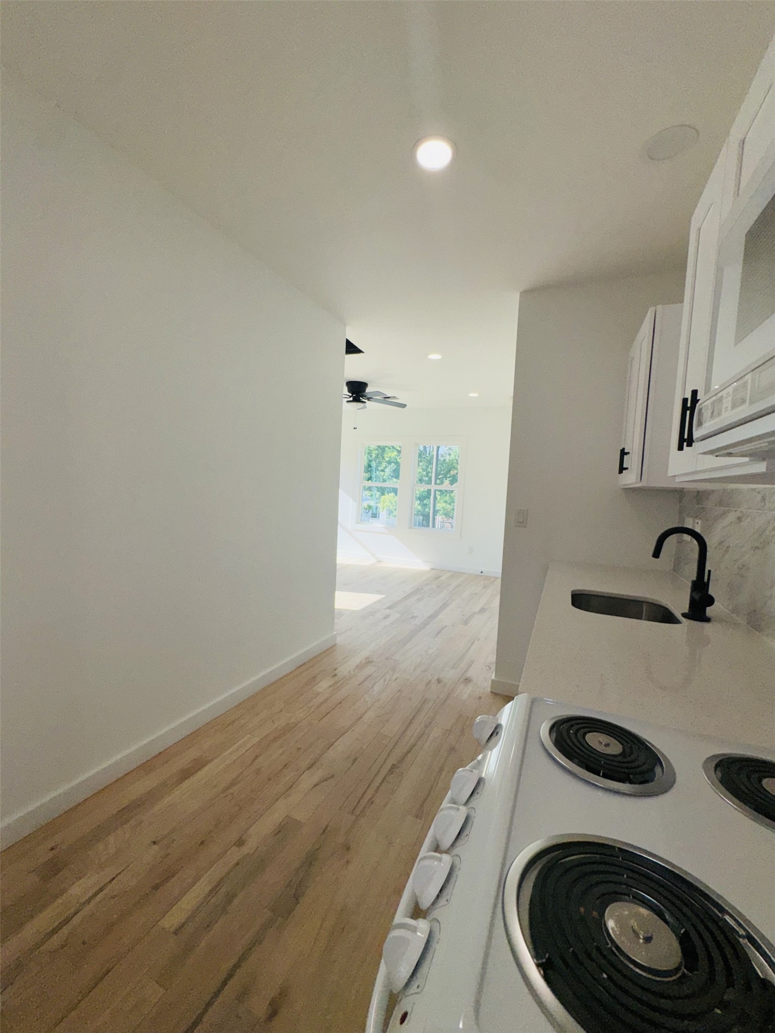 1235 West Gray Street, Unit 1 Houston, TX 77019 - Photo 6 of 10 a view of a kitchen with a sink and a stove top oven