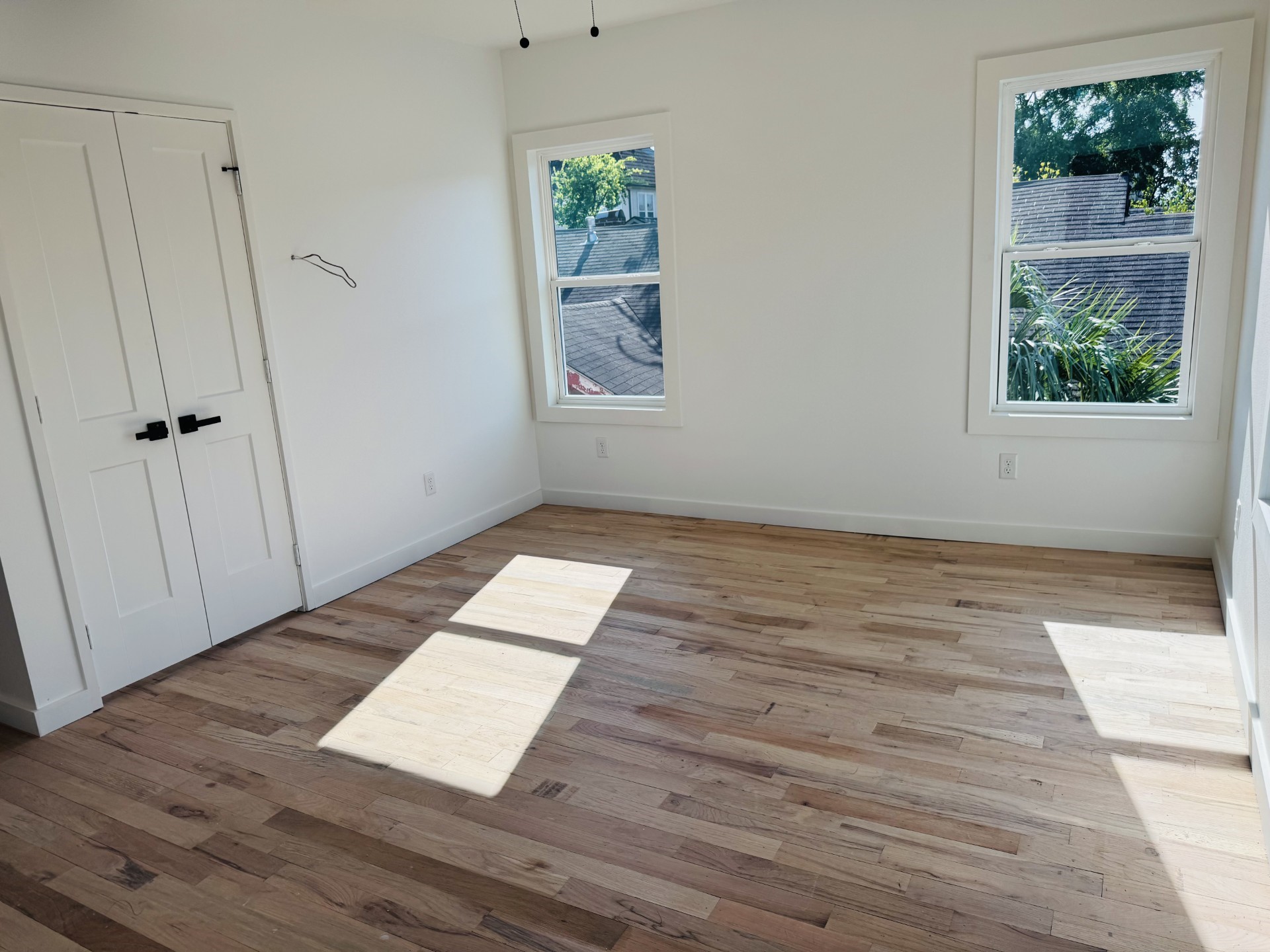 1235 West Gray Street, Unit 1 Houston, TX 77019 - Photo 8 of 10 an empty room with wooden floor and windows