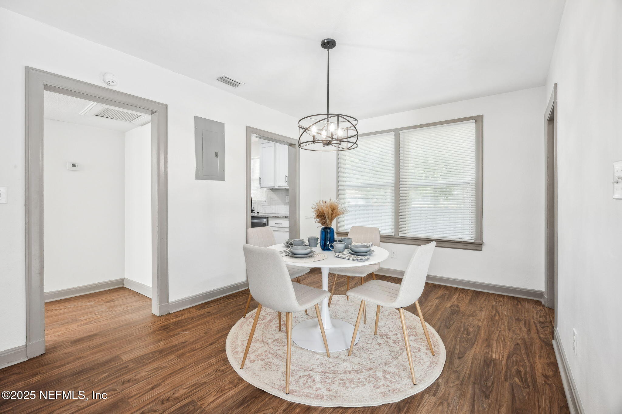 4615 Woolman Avenue Jacksonville, FL 32205 - Photo 14 of 34 a view of a dining room with furniture window and wooden floor