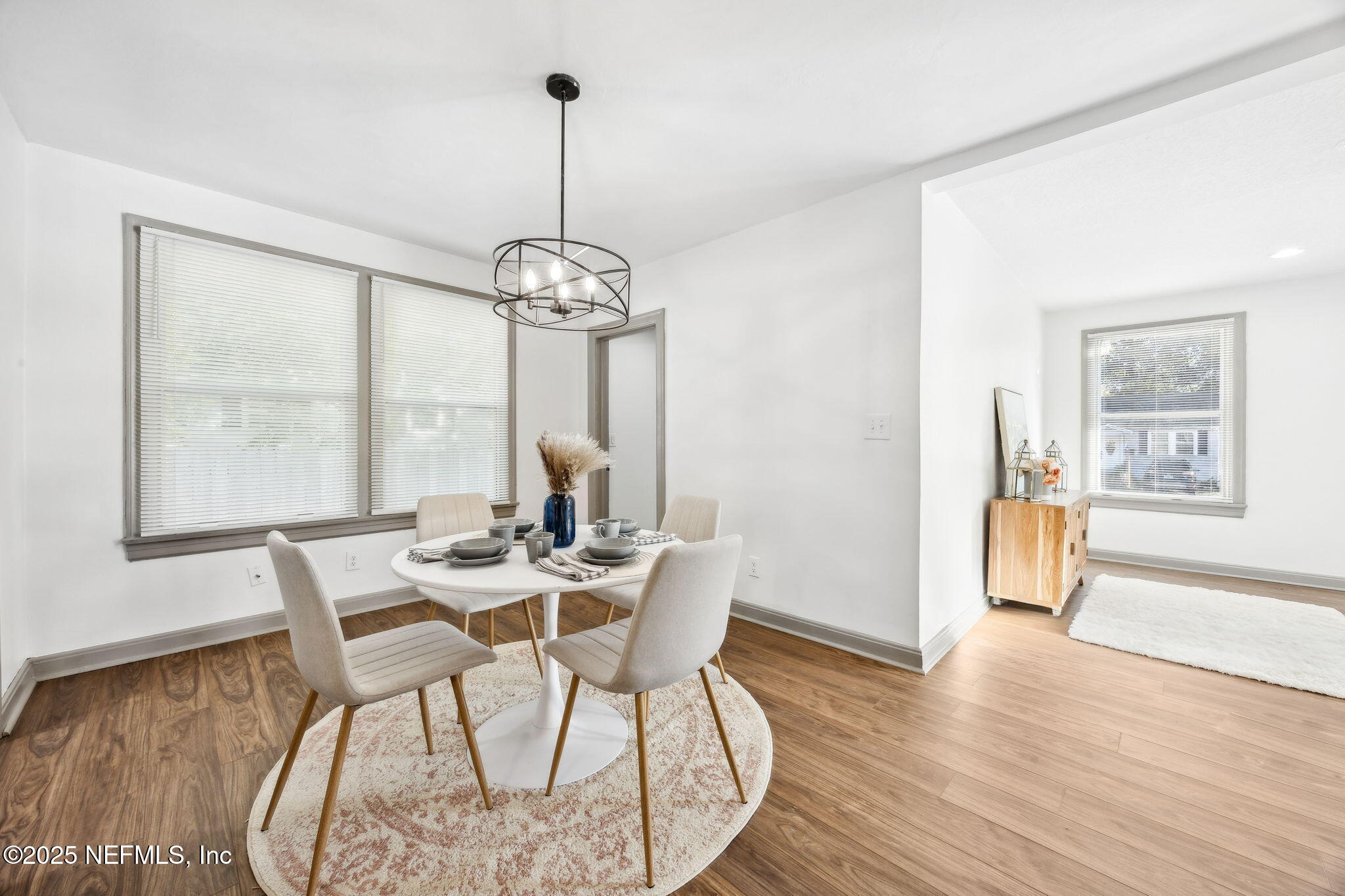 4615 Woolman Avenue Jacksonville, FL 32205 - Photo 15 of 34 a view of a dining room with furniture window and wooden floor