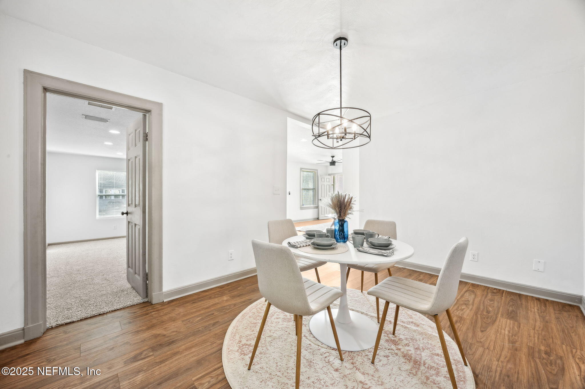4615 Woolman Avenue Jacksonville, FL 32205 - Photo 16 of 34 a view of a dining room with furniture wooden floor and chandelier