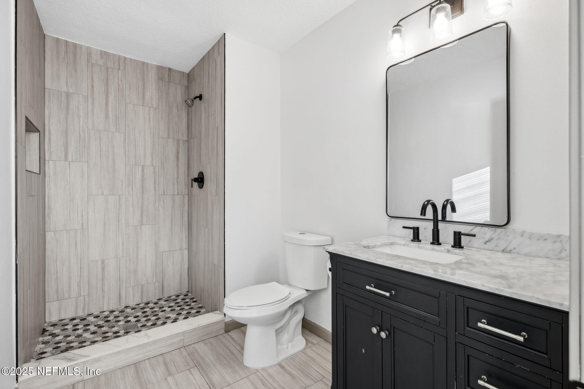 4615 Woolman Avenue Jacksonville, FL 32205 - Photo 23 of 34 a bathroom with a sink a toilet and shower