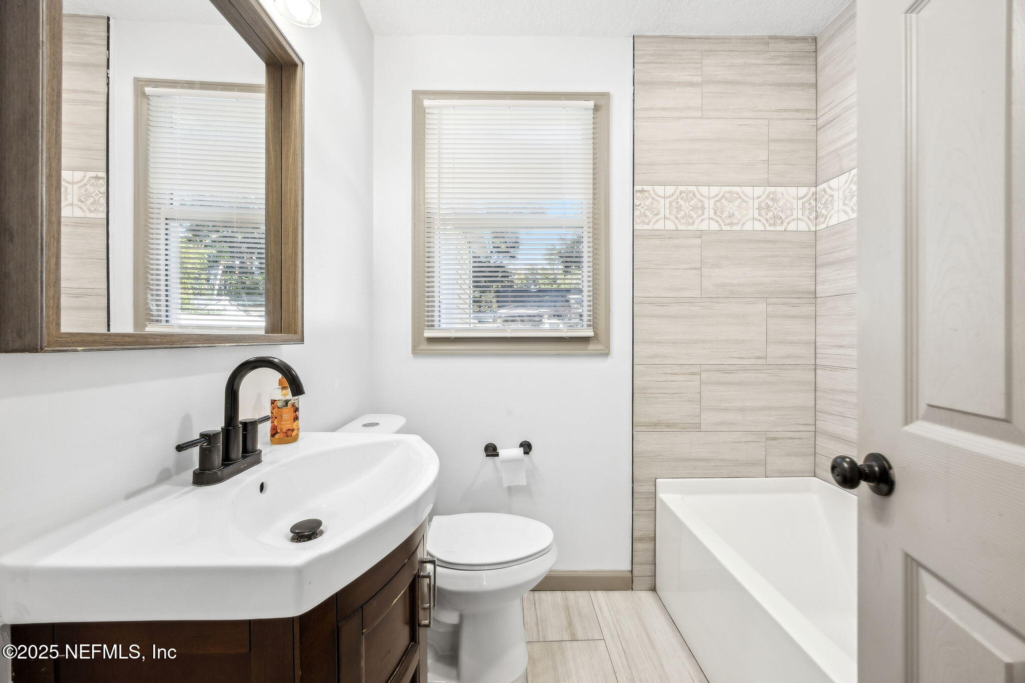 4615 Woolman Avenue Jacksonville, FL 32205 - Photo 26 of 34 a bathroom with a sink toilet and shower