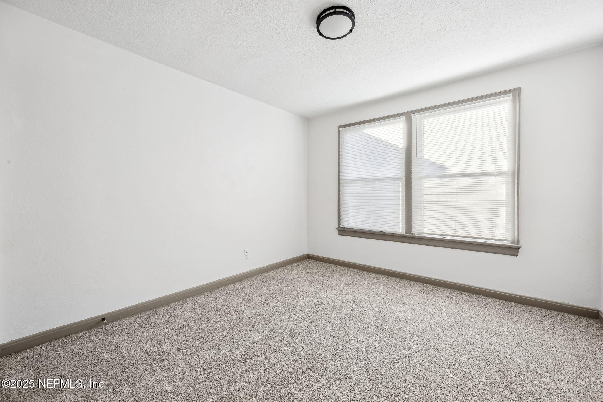 4615 Woolman Avenue Jacksonville, FL 32205 - Photo 27 of 34 an empty room with a window