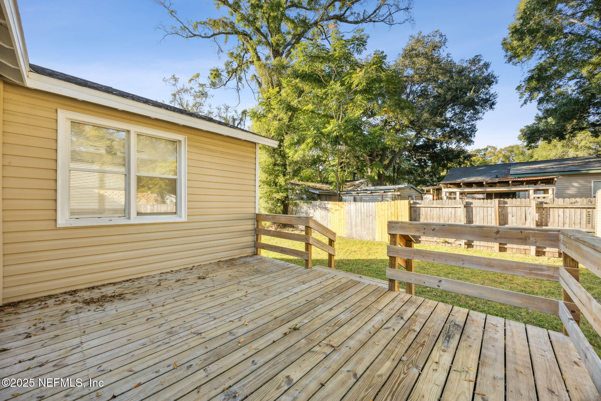 4615 Woolman Avenue Jacksonville, FL 32205 - Photo 30 of 34 a view of a roof deck with wooden floor and fence