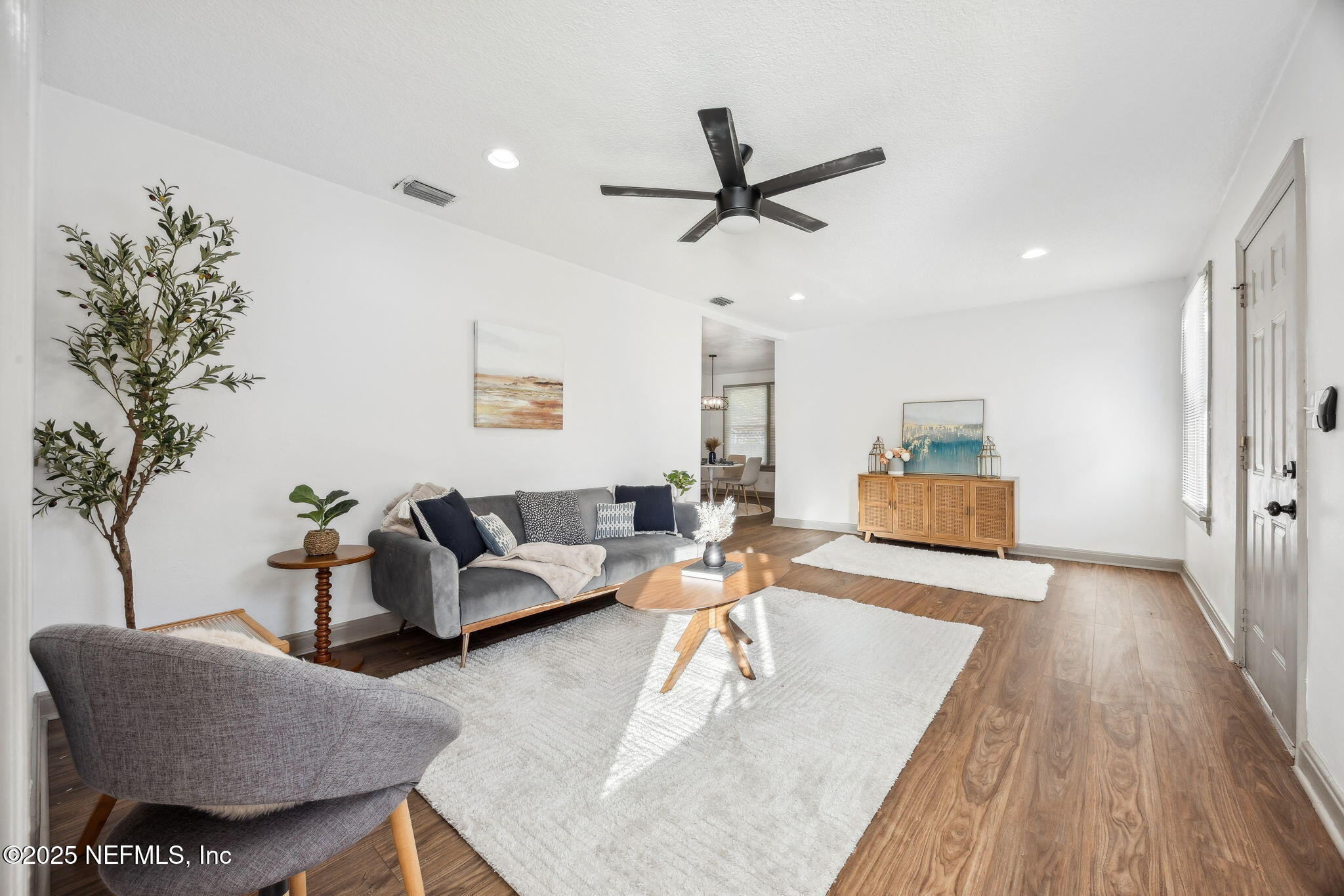 4615 Woolman Avenue Jacksonville, FL 32205 - Photo 10 of 34 a living room with furniture and a wooden floor