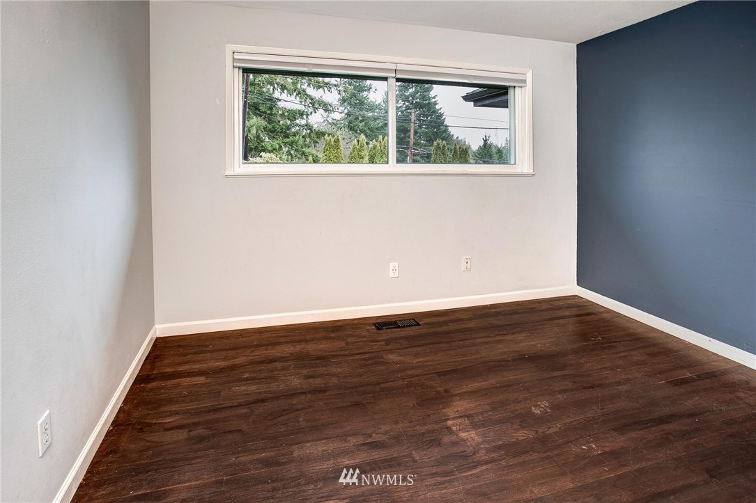 24326 Meridian Avenue South Bothell, WA 98021 - Photo 18 of 40 an empty room with wooden floor and windows