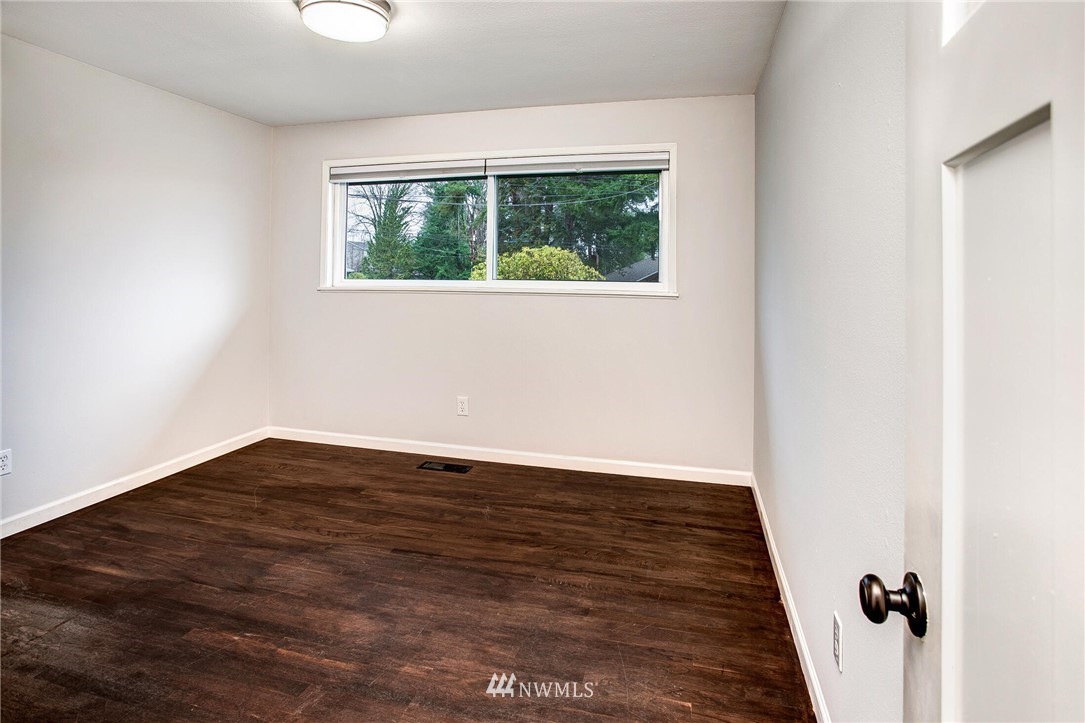 24326 Meridian Avenue South Bothell, WA 98021 - Photo 19 of 40 an empty room with wooden floor and windows