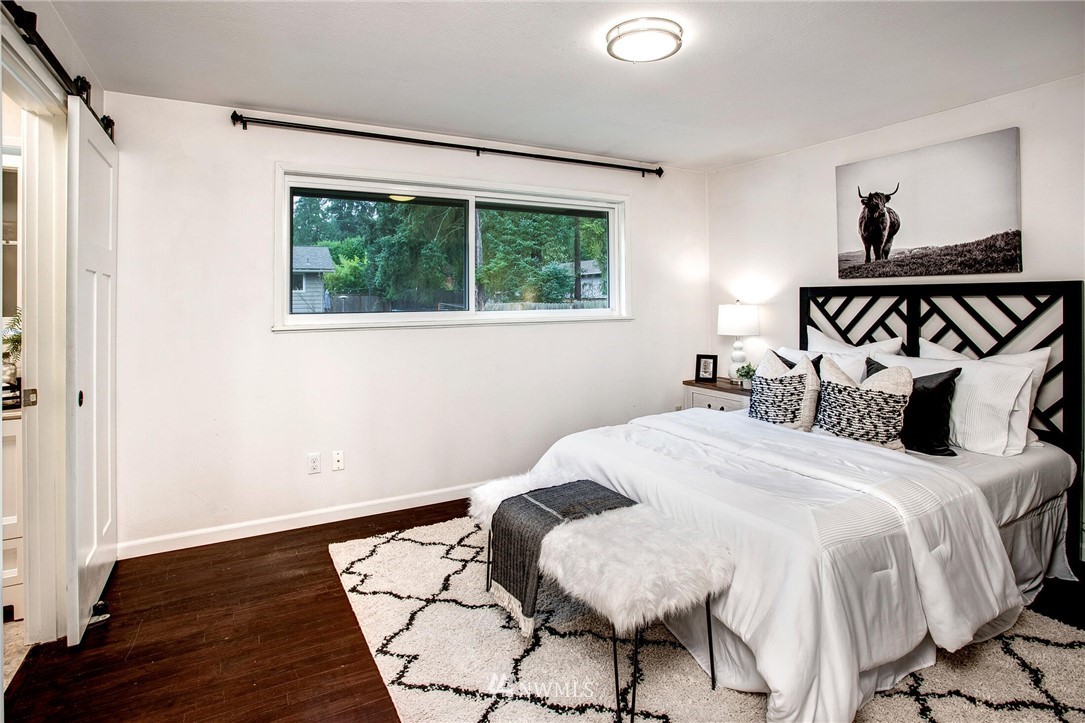 24326 Meridian Avenue South Bothell, WA 98021 - Photo 20 of 40 a bedroom with a bed and wooden floor