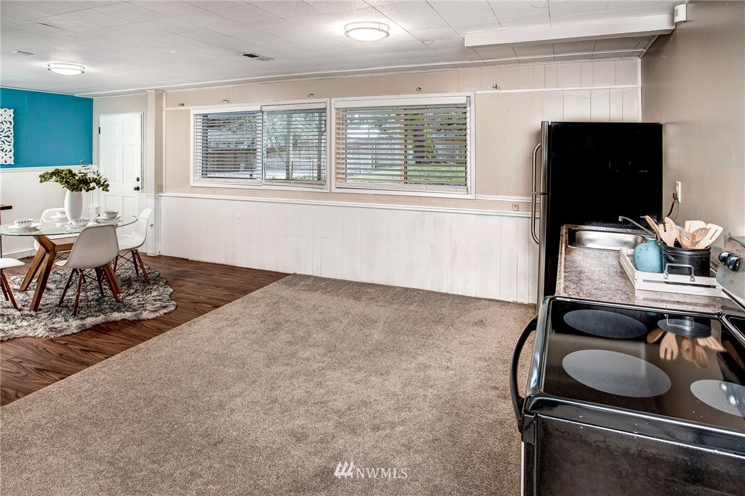 24326 Meridian Avenue South Bothell, WA 98021 - Photo 25 of 40 a living room with furniture and a flat screen tv