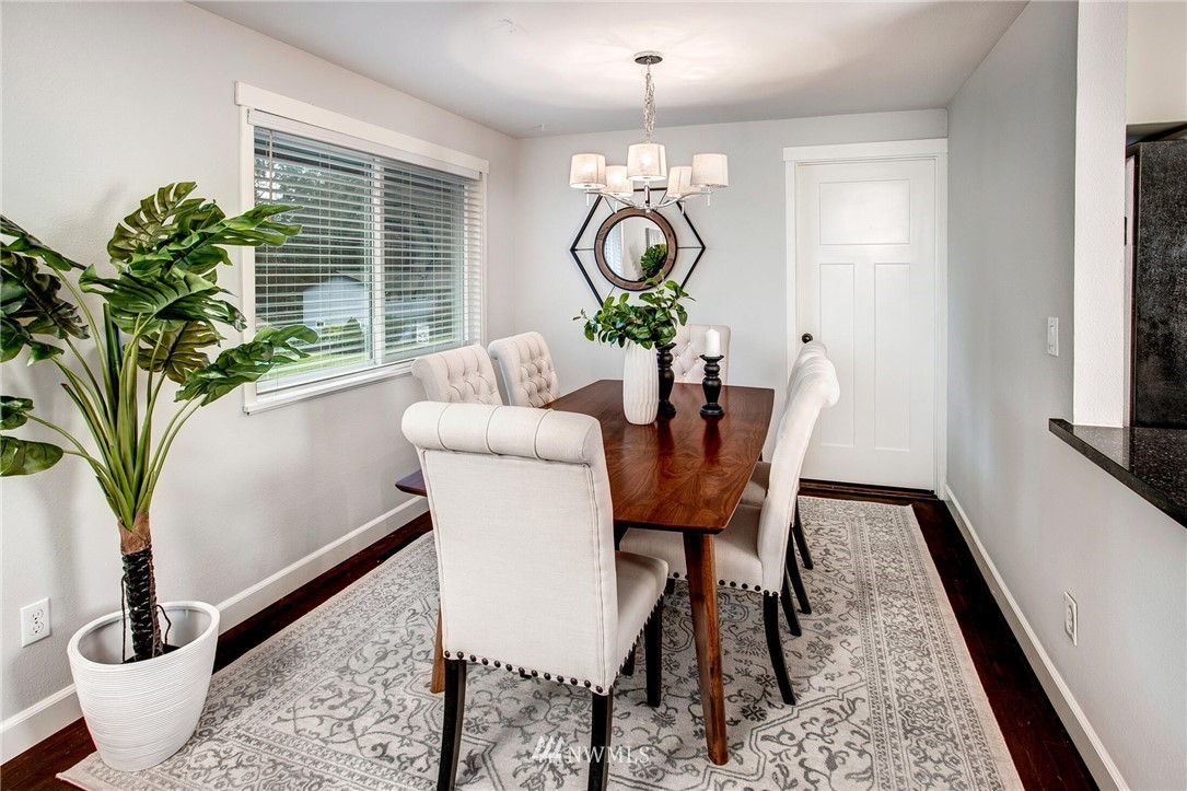 24326 Meridian Avenue South Bothell, WA 98021 - Photo 8 of 40 a dining room with furniture potted plants and wooden floor
