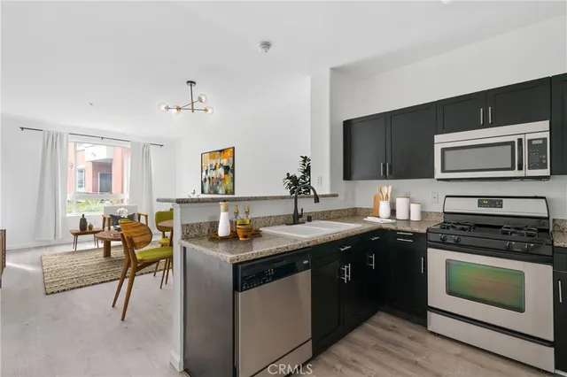 a kitchen with a sink stove and microwave