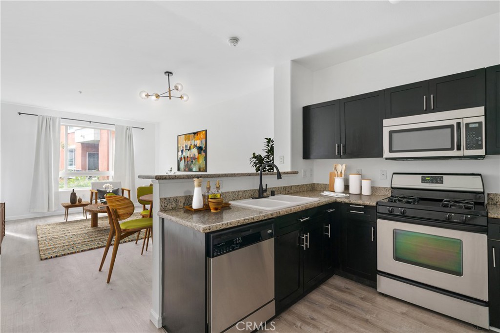 100 South Alameda Street, Unit 213 Los Angeles, CA 90012 - Photo 1 of 41 a kitchen with a sink stove and microwave
