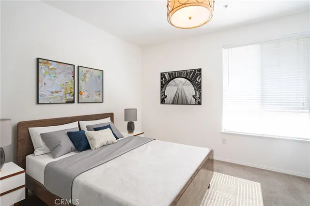 a bedroom with a bed and a painting on the wall