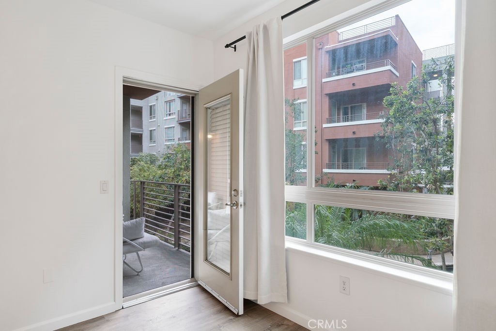 100 South Alameda Street, Unit 213 Los Angeles, CA 90012 - Photo 13 of 41 a view of a room with a large window and wooden floor