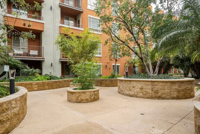 a view of a house with fountain in front of house
