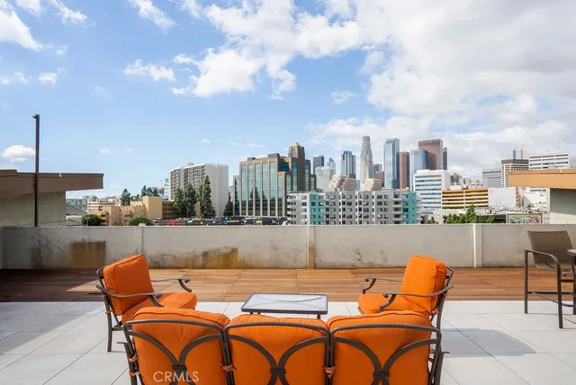 a outdoor sitting area with furniture and city view