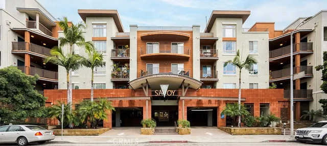 a front view of a building with a garden