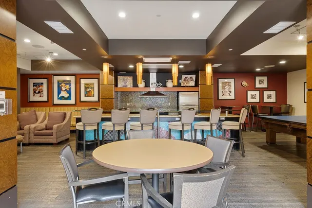 a dining room with lots of furniture and a wooden floor