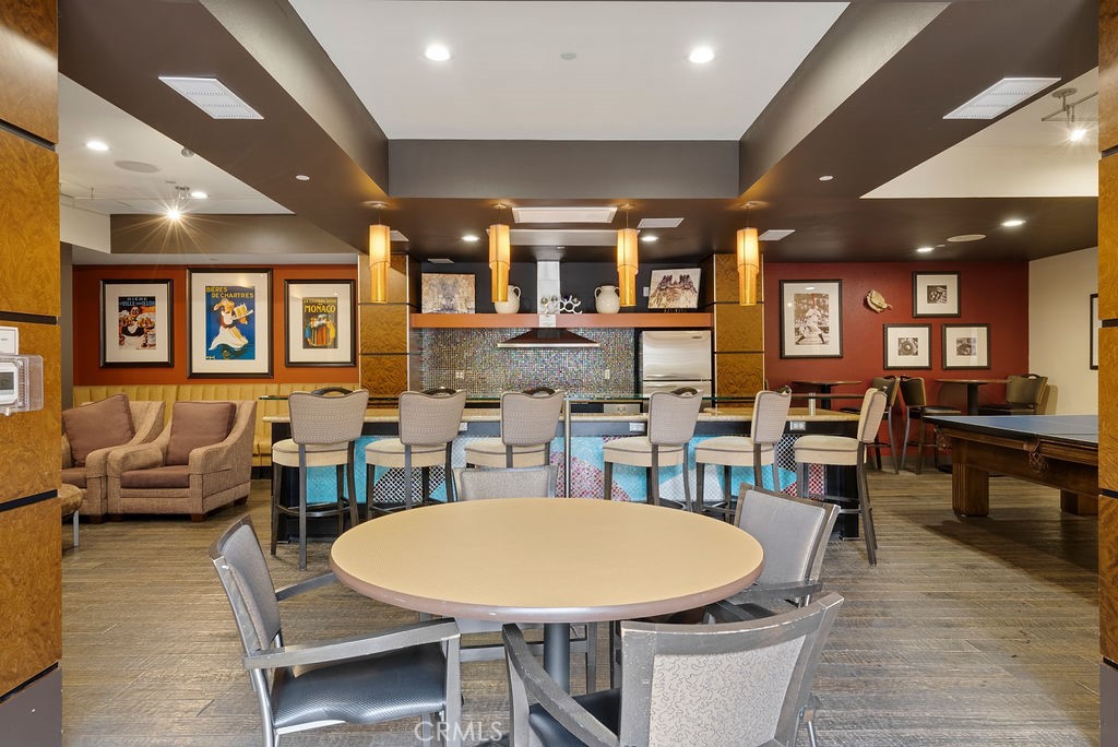 100 South Alameda Street, Unit 213 Los Angeles, CA 90012 - Photo 29 of 41 a dining room with lots of furniture and a wooden floor