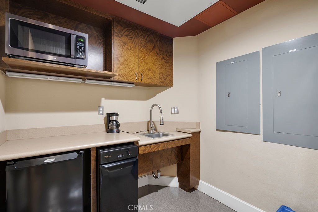 100 South Alameda Street, Unit 213 Los Angeles, CA 90012 - Photo 35 of 41 a kitchen with a sink and a microwave